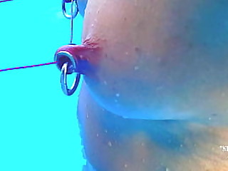 nippleringlover kinky extreme stretched nipple piercings tied together with tight rope outside in swimmingpool